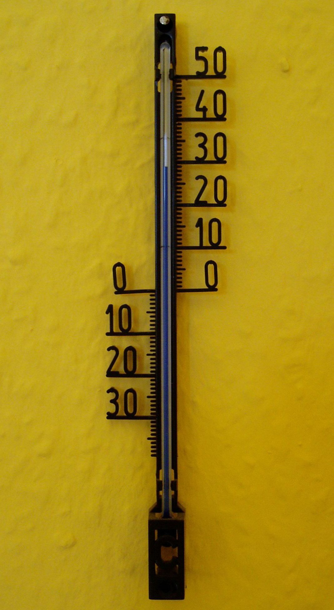 An outdoor thermometer during a summer heat wave
